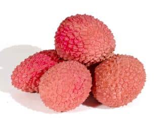 Health benefits of lychee, a small pile of fruit against a white background