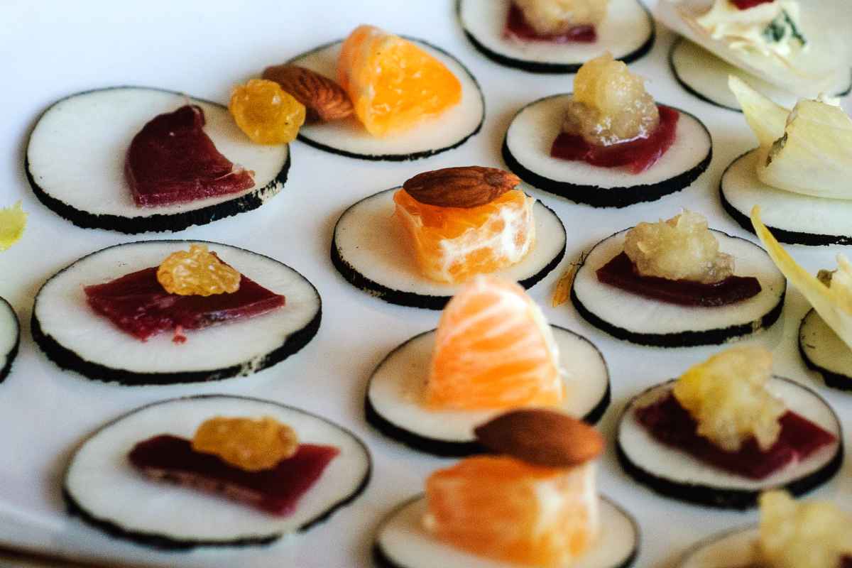 Black radish sliced and topped with healthy canapés appetizers