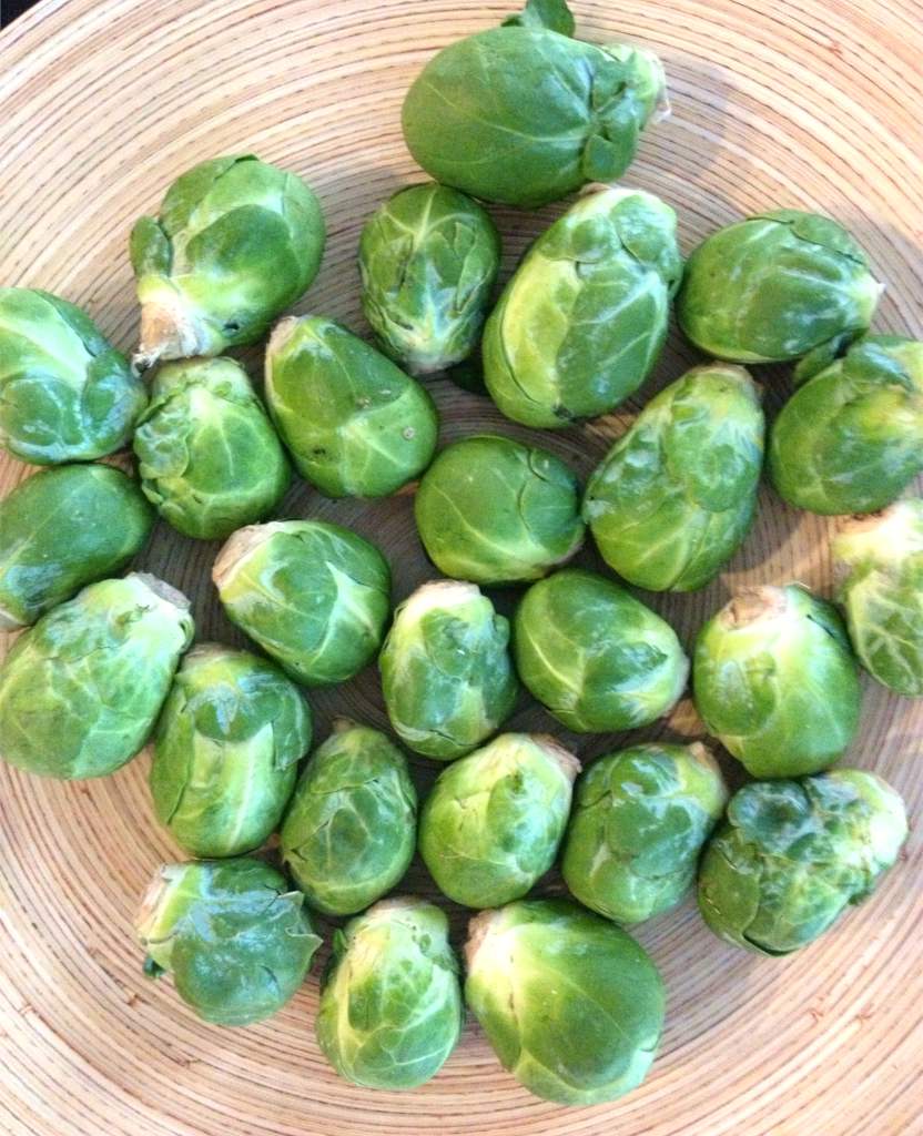 Brussels sprouts peeled and laid out on a cutting board, ready for a winter meal.