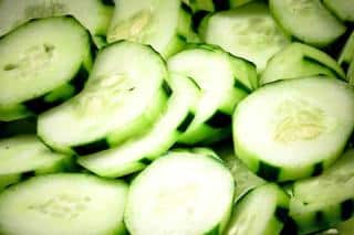 Cucumber slices with portions of the skin unpeeled