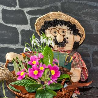 Puppet ornament with crocus, snowdrops and pansy flowers