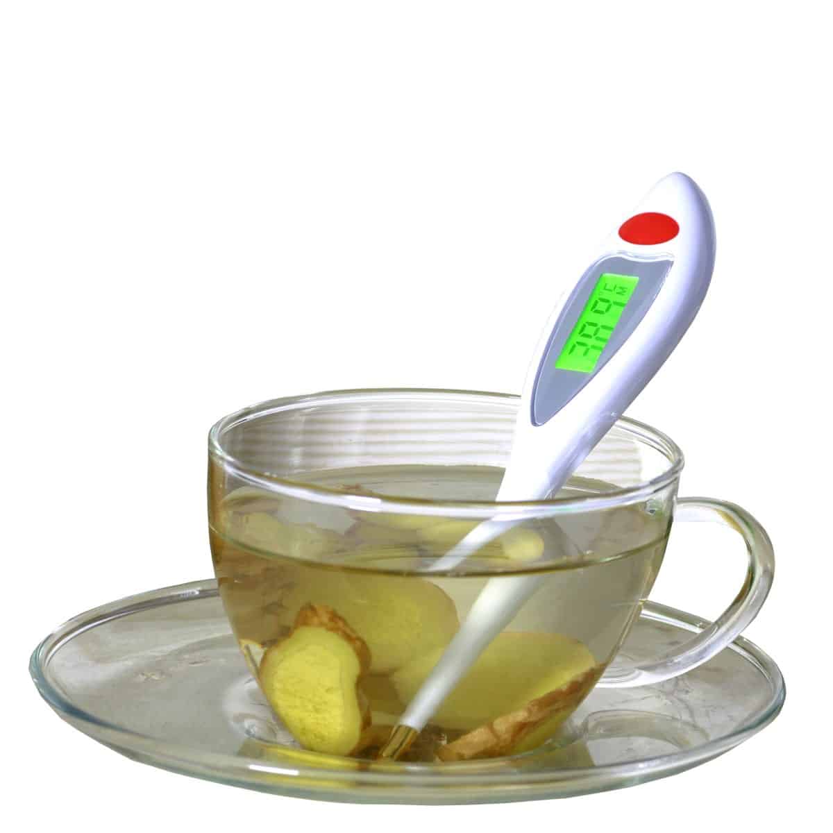 Cup and saucer with thermometer and ginger