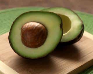 Raw avocado sliced in two is very healthy.
