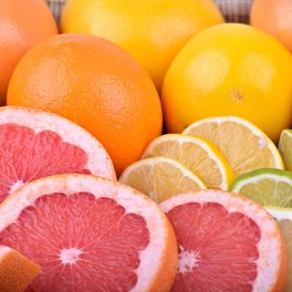 Citrus fruits, some of which are sliced.