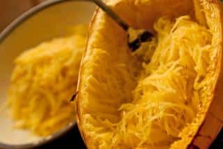 Spooning out the spaghetti from a spaghetti squash - with a fork!