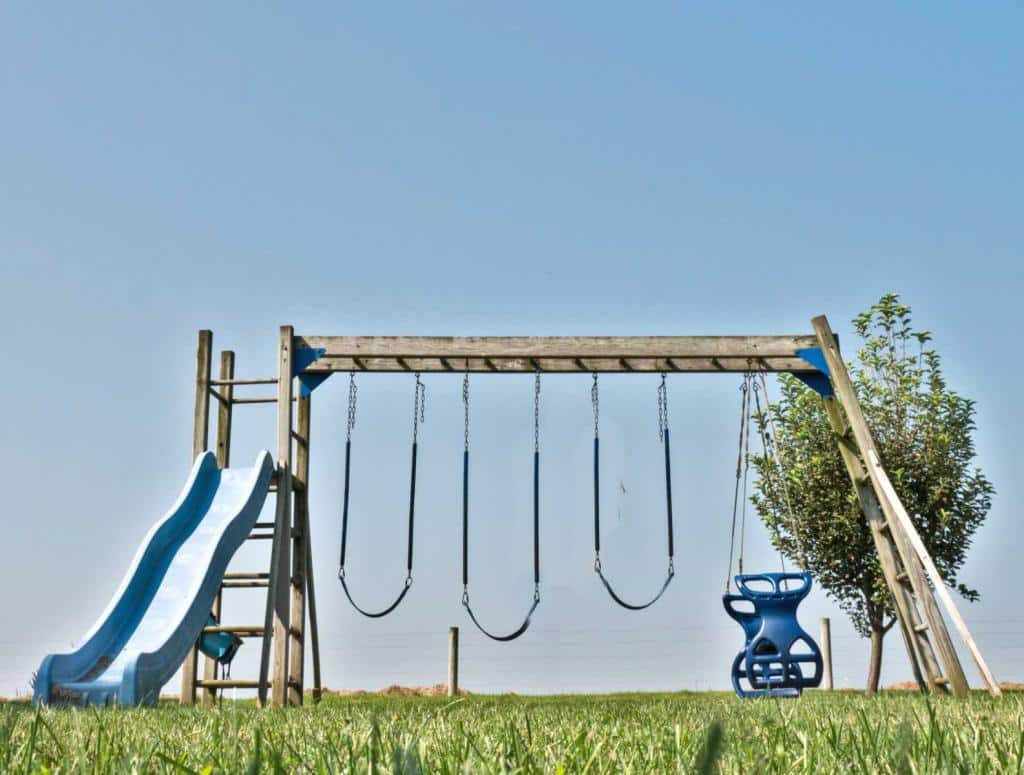 Wooden swingset with 5 activities.