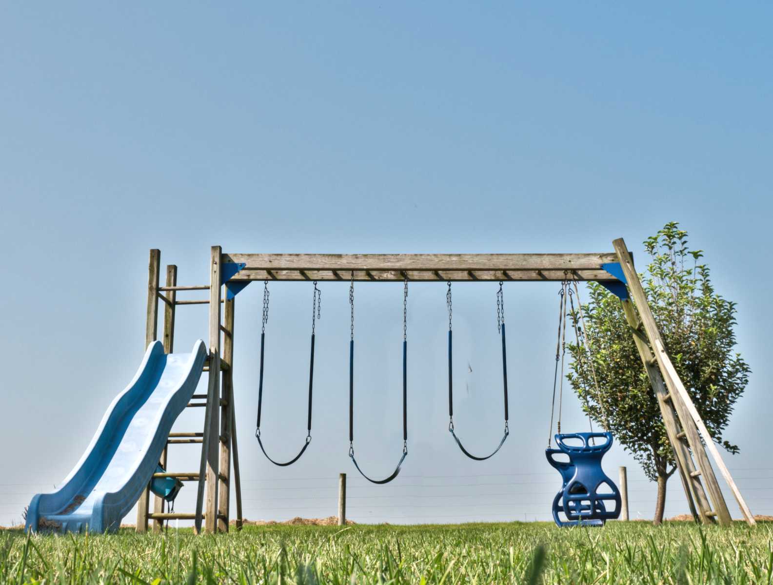 Wooden swingset with 5 activities.