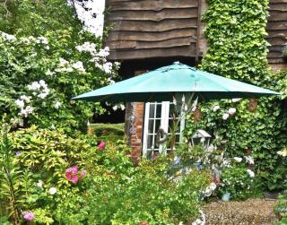 Landscaped narrow garden with a table at the entrance