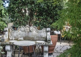 Cozy bench corner hidden in a long narrow garden