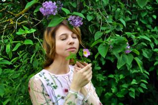 Young girl taking in garden scents