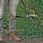 Man with hedge trimmer on standby