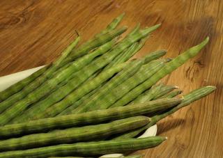 Moringa oleifera seed pods, harvested and in a plate