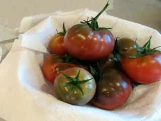 Harvest of Black crimea tomato in a basket