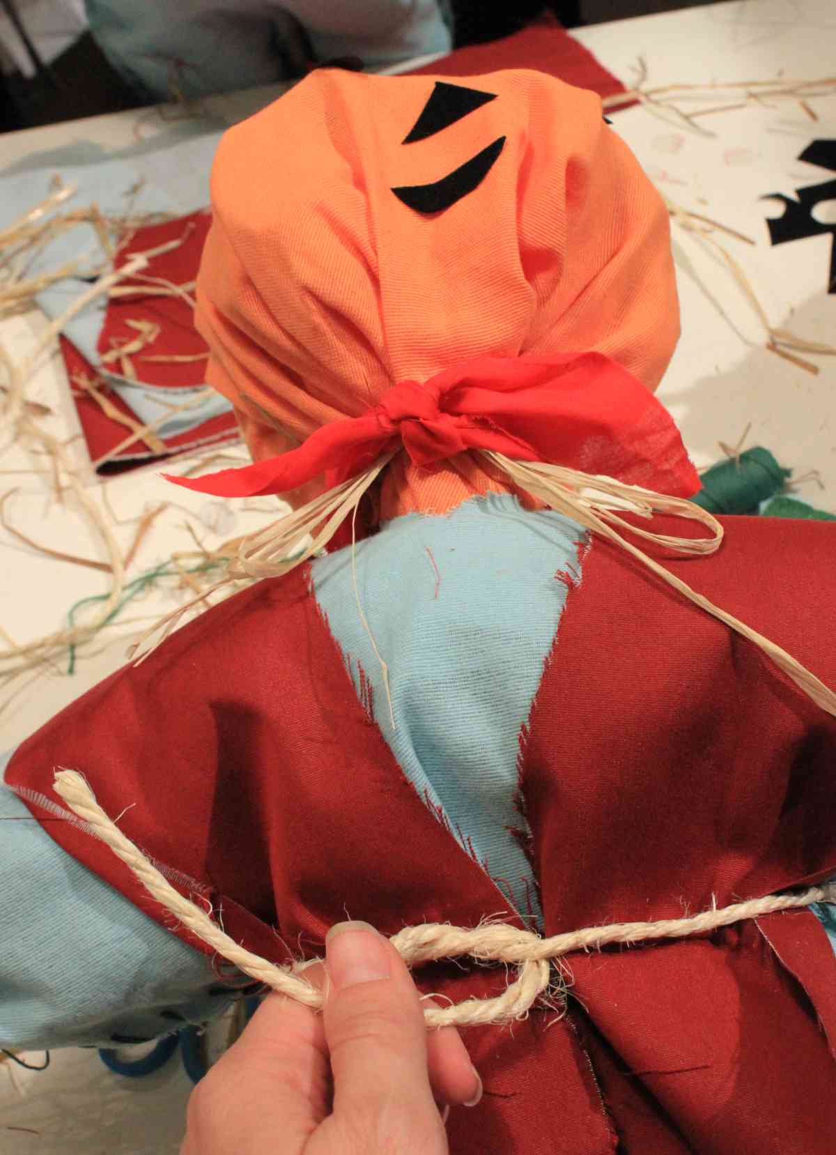 Head and torso of the scarecrow, in this step tying a belt