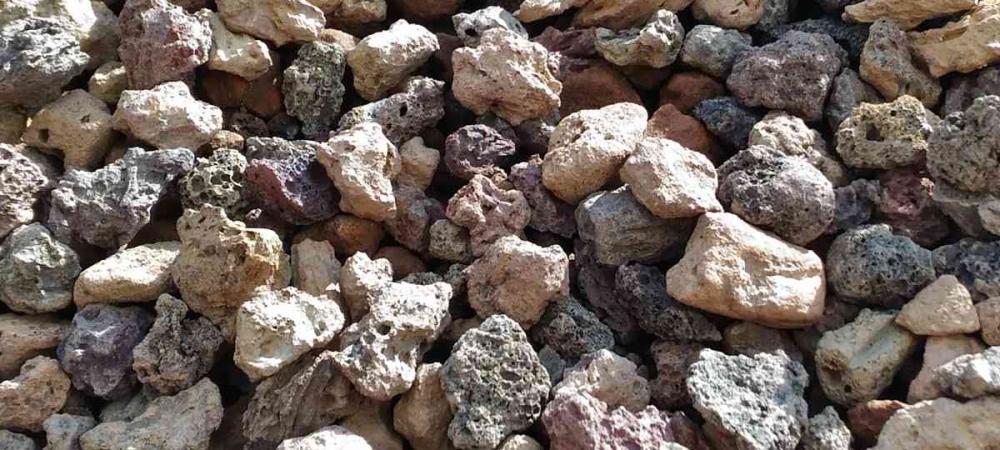 Pozzolana pebbles have many tiny holes and cavities that retain water and air