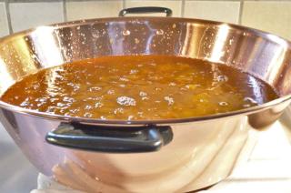 Orange marmalade boiling in a copper pot