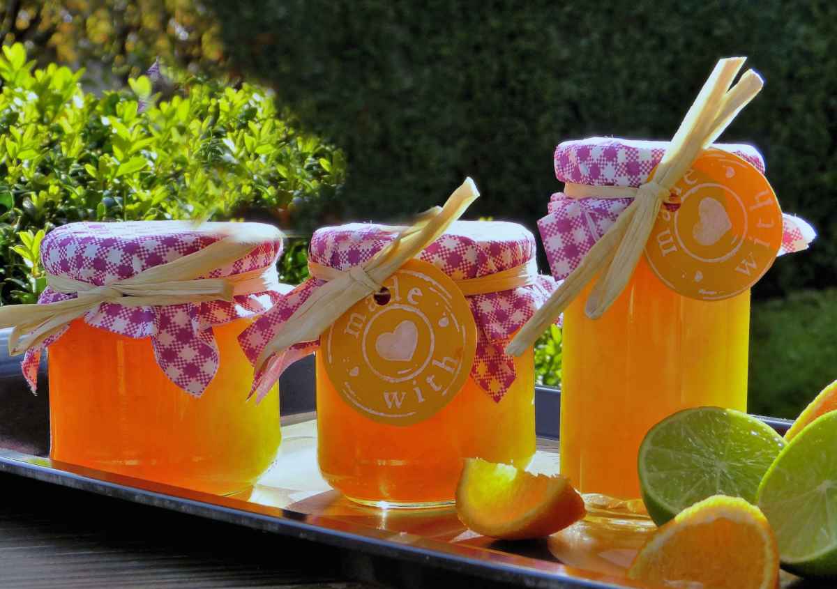Recipe for orange marmalade, three jars filled with the delicious jam