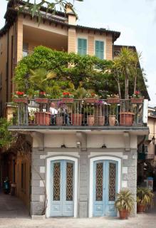 A garden with many flowered pots and containers on a balcony